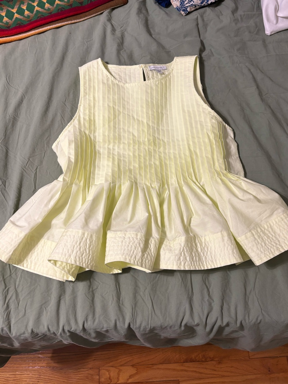 Sleeveless Pleated Peplum Top in Light Yellow